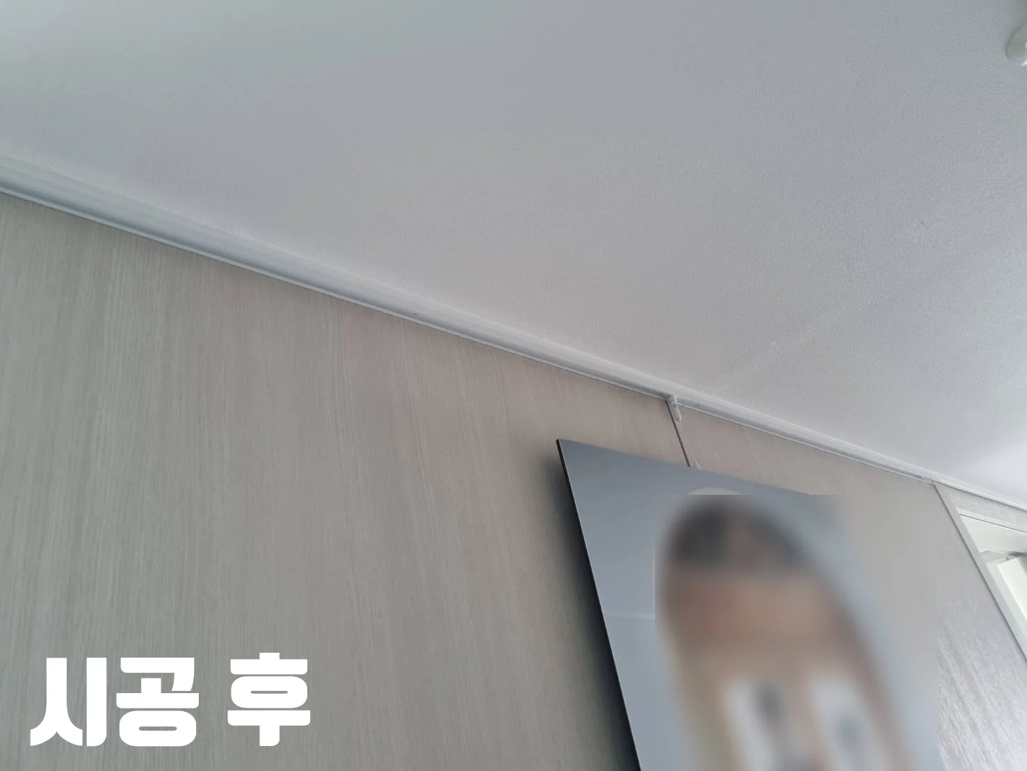 시공 후 문구와 함께 아트월 액자레일에 웨딩사진을 건 모습